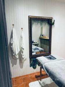 Die Ou Pastorie في هارتبيسبورت: مرآة على جدار مع سريرين في غرفة