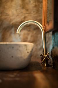 a sink with a faucet on a counter at Mtoni River Lodge in Arusha