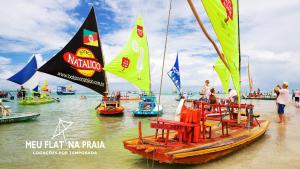 a group of boats in the water near a beach at Flat no Centro 1 Quarto com varanda - 50m Piscinas das Naturais in Porto De Galinhas +21 photos