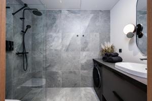 a bathroom with a shower and a sink at Siili Riverview Stay in Tartu +12 photos