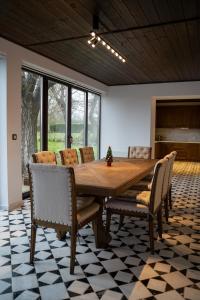 a dining room with a wooden table and chairs at Вила Вяра, Надежда, Любов in Neofit Rilski