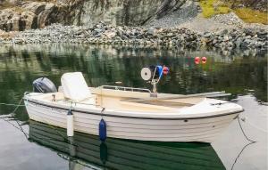 a boat is docked in a body of water at Holiday Home Finnås Lykling in Lykling +12 photos