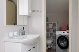 a bathroom with a sink and a washing machine at Large and charming apartment near beach with big & sunny terrace in Sumartin +41 photos