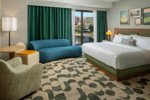 a hotel room with a bed and a chair at Trilogy Hotel Huntsville, Autograph Collection in Huntsville +38 photos