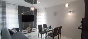 a living room with a couch and a table with chairs at Good Place Kodowa in Skorka