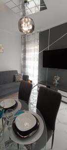 a living room with a glass table and chairs at Good Place Kodowa in Skorka