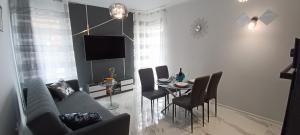 a living room with a couch and a table with chairs at Good Place Kodowa in Skorka +15 photos