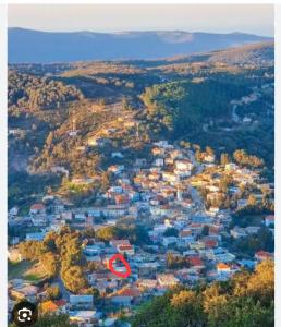 an aerial view of a town with a red circle at Ain draham sejour 2, appartement trois pièces privé, seulement familles in Bābūsh