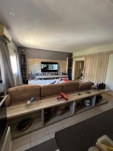 un soggiorno con un divano marrone e un tavolo di ACONCHEGANTE Quarto a Rio Verde Altre 4 foto