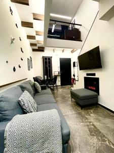 a living room with a couch and a tv at Modern Home Loft in Alexandroupoli