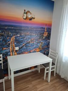 a white table in a room with a view of the city at Butas Putinuose in Alytus