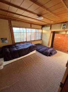 Ένα ή περισσότερα κρεβάτια σε δωμάτιο στο 萩乃庵