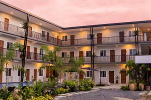 an apartment building with a courtyard with trees at Bayview Garden Resort in Tagbilaran City
