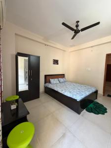 a bedroom with a bed and a ceiling fan at Da Nest in Guwahati