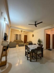 a living room with a table and chairs and a couch at Da Nest in Guwahati