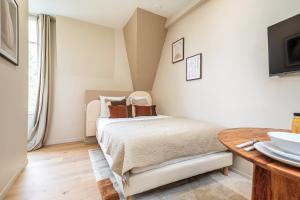 Postel nebo postele na pokoji v ubytování Charming air-conditioned studio