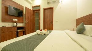 a bedroom with a bed with two stuffed animals on it at The Namami Tapovan in Rishīkesh