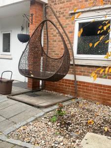 a swing hanging from the side of a house at Warn Cossy Luxe Room in Addington
