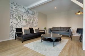 a living room with a couch and a coffee table at Maison avec espace bien-être privé in Mareuil-sur-Lay