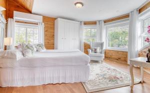 a white bedroom with a large bed and windows at Villa Carlitos by Villas Vista Gomera in Adeje +23 photos