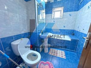 un bagno piastrellato blu con un water e un lavandino di Apartament Calea Severinului - 2 camere a Craiova