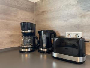 two coffee makers and a microwave on a counter at Apartment Rooftop - Dresden trifft Sächsische Schweiz! in Dresden