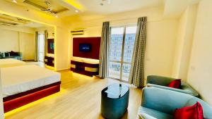 a hotel room with a bed and a couch at Hotel Four Season - Gomtinagar - Lucknow in Lucknow