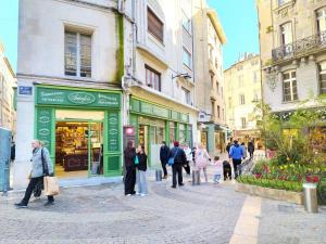 a group of people walking down a street at Studio lumineux Avignon centre, proche de tout in Avignon