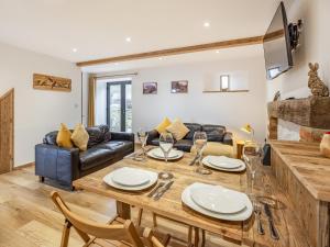 a living room with a table and a couch at The Hayloft-Uk34015 in Godshill
