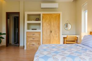 een slaapkamer met een bed en een houten kast bij Luxury Villa - Pool - Gym - Steam Room - Garden in Ko Pha Ngan