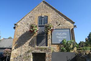 a building with a sign on the side of it at The Helyar Arms in Yeovil