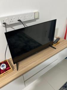 a large flat screen tv sitting on top of a table at Homestay Kesidang in Seri Iskandar
