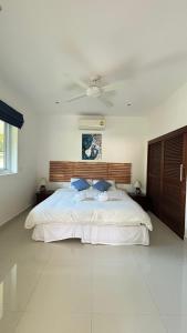 a bedroom with a large white bed with a ceiling at Villa Sun 4 in Mae Nam +22 photos
