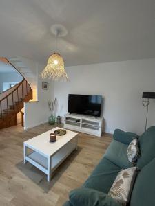 a living room with a couch and a coffee table at La maison du viaduc in Chauvigny