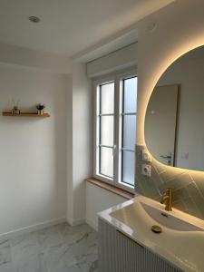 a bathroom with a sink and a mirror at La maison du viaduc in Chauvigny +34 photos