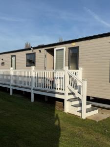 een stacaravan met een veranda en een terras bij Bishops Beach Stays in Walton-on-the-Naze +18 foto's