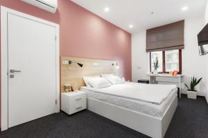 Postel nebo postele na pokoji v ubytování Orange Hotel + 37 fotografií