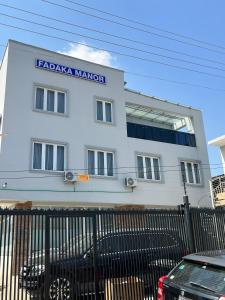 a white building with a sign that reads lacada mannar at Fadaka Manor in Ibadan