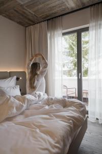 a woman standing in front of a bed at Alpvita Piz Tasna in Ischgl