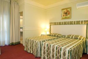 Rúm í herbergi á Park Hotel Villaferrata