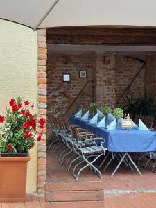 a blue table and chairs on a patio at Gasthof-Hotel Maintal in Bad Staffelstein +4 photos