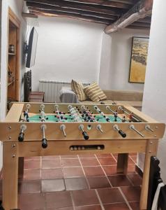 a wooden foosball table in a living room at Casa La Fuencisla in Castiltierra