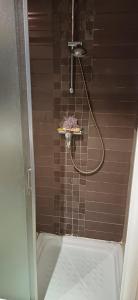 a shower with a hose in a bathroom at Maison 3 in Sidi Daoud