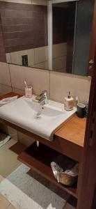 a bathroom with a sink and a mirror at Maison 3 in Sidi Daoud
