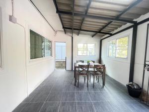 a dining room with a table and chairs at Haiya Holiday House 2 in Ban Hua Phrong
