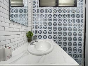 a white bathroom with a sink and a mirror at Haiya Holiday House 2 in Ban Hua Phrong
