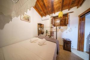 Postel nebo postele na pokoji v ubytování Maison Des Vignes Lofou