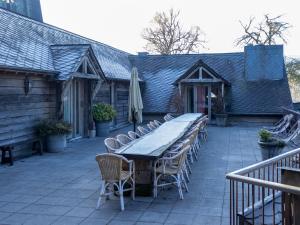 a long table and chairs on a patio at Vielsalm Stay with furry friends in Vielsalm