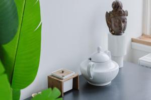 a tea pot and a box on a table at Copenhagen Studio Double Bed and Kitchen 3 in Copenhagen