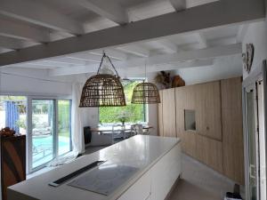 a kitchen with two pendant lights above a counter at Casa del Cielo in La Cumbre